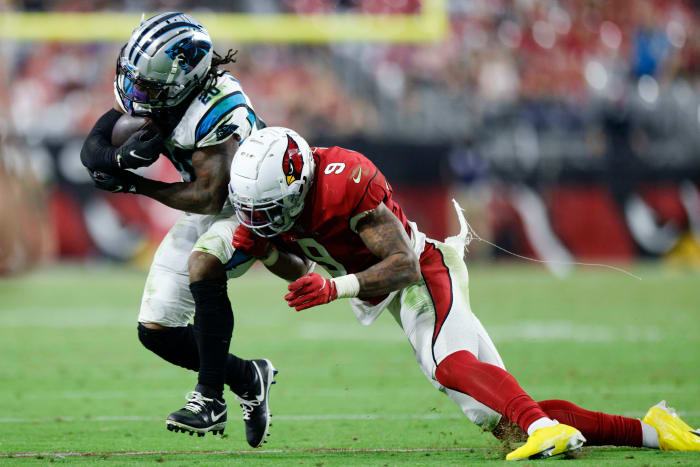 running back Ameer Abdullah runs with the ball in his hands as Arizona Cardinals linebacker Isaiah Simmons leans to tackle him